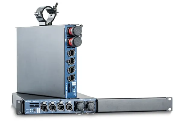 Two blue and black audio interface units with multiple input/output ports are shown. One unit stands vertically with a mounting bracket on top, while the other lies flat with ports facing forward—ideal for professional audio or video setups.